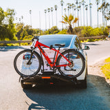 Red electric bike loaded onto Destination E hitch rack on SUV.