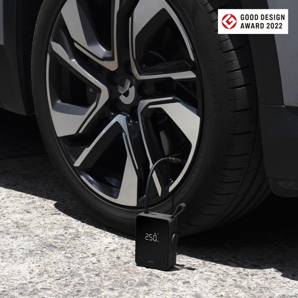 HOTO Electric Air Pump inflating a car tire, showing 25.0 psi on display.