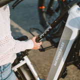 Person holding Hollywood Racks Bike Adapter on electric bike.