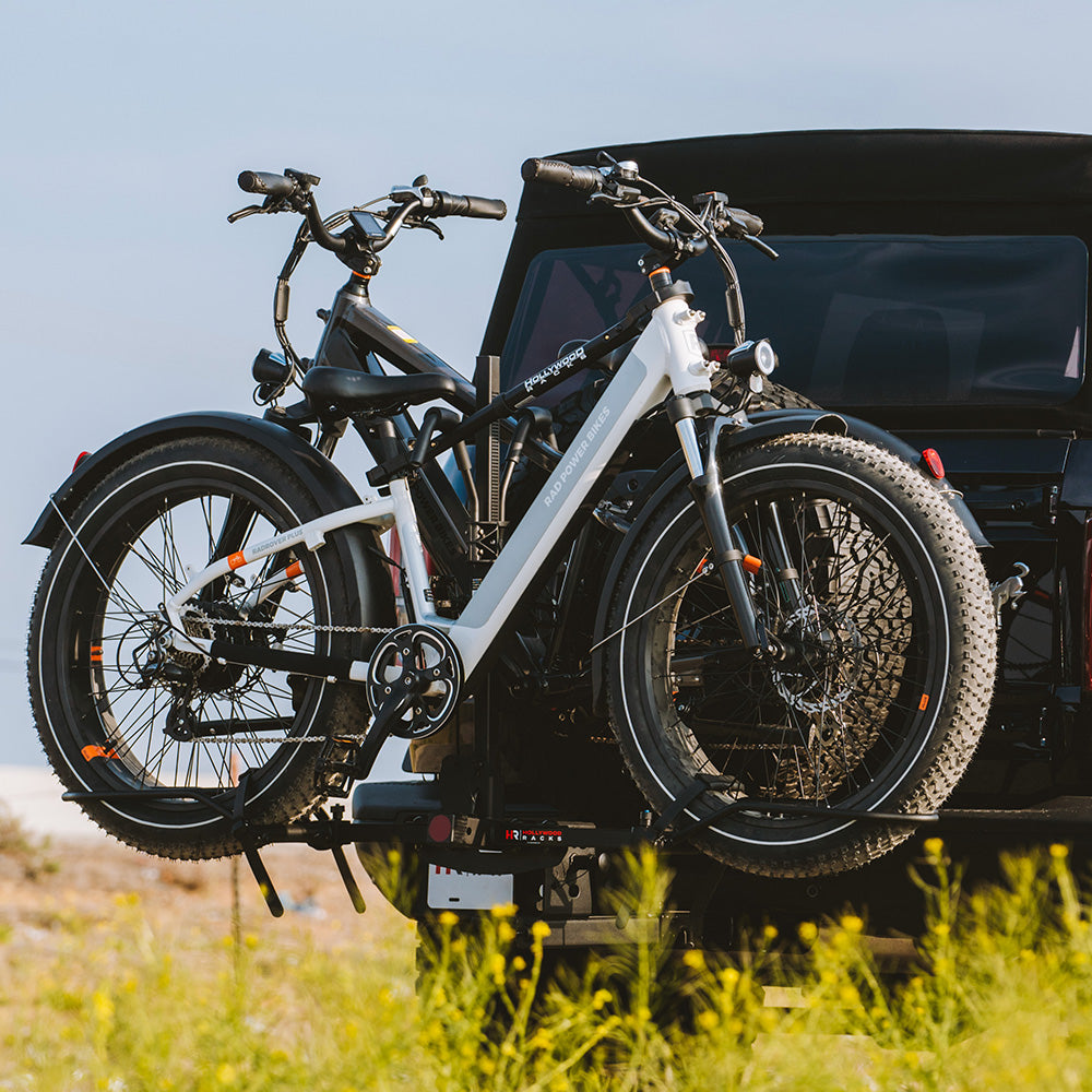 Two electric bikes on rack using Bike Adapter Pro for sloping top tubes.