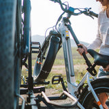 User installing Bike Adapter Pro on electric bike for transport.
